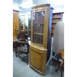 A walnut freestanding corner cabinet