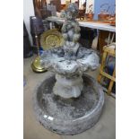 A classical figural concrete bird bath