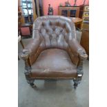 A Victorian carved oak and leather upholstered library armchair