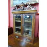 A mahogany wall mounted display cabinet, bearing Asprey Jewellers, London inscription to the