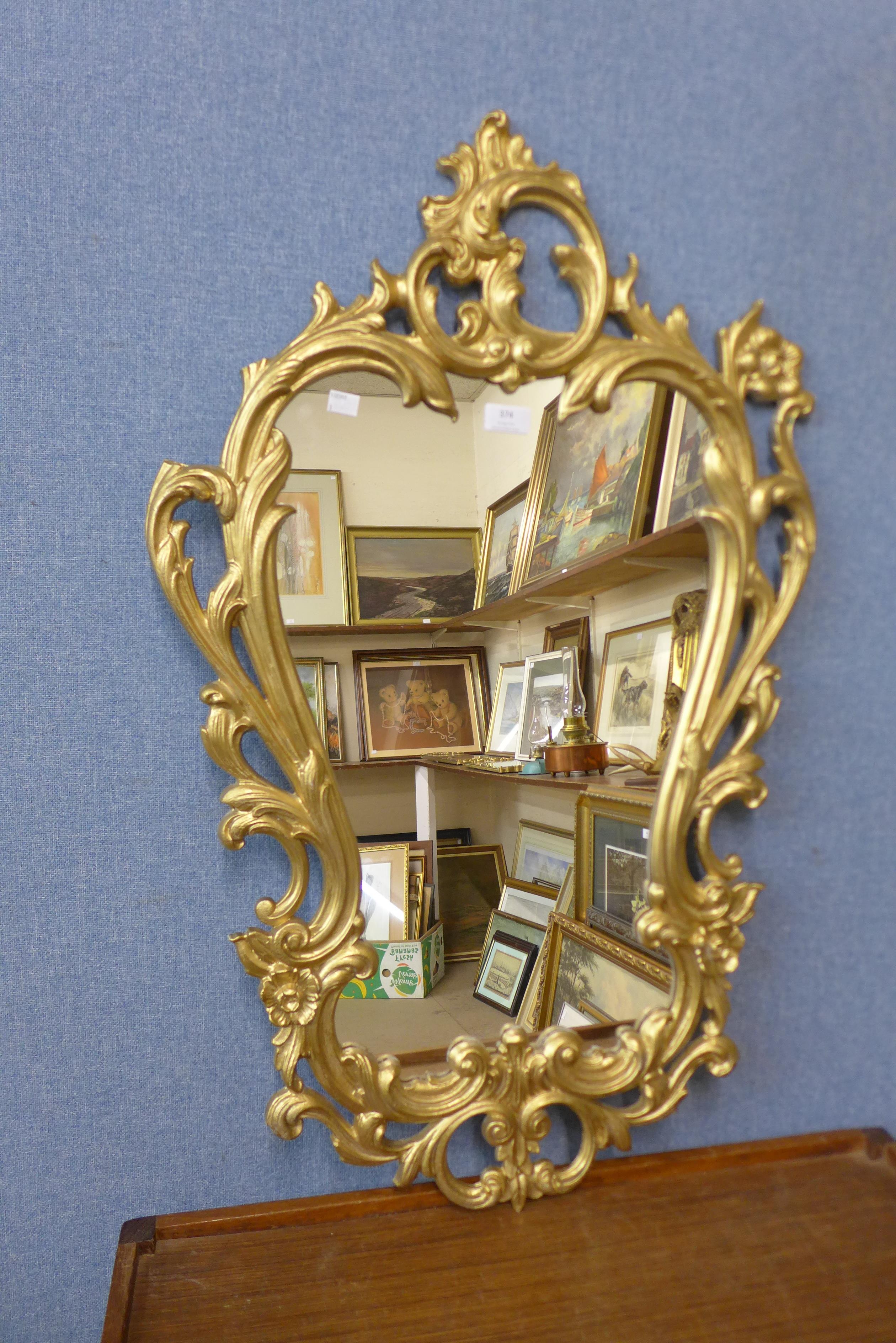 A rococo style gilt framed mirror