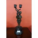 A French style bronze figure of a boy holding flowers, on black marble socle