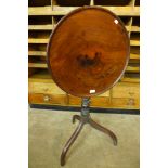 A George III mahogany circular tilt top tripod table