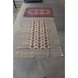 A cream ground rug and a red rug