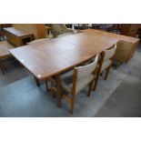 A Danish teak extending dining table and four chairs