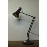 A browm metal anglepoise desk lamp