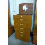 A teak chest of drawers