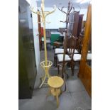 Two beech bentwood coat stands and a stool