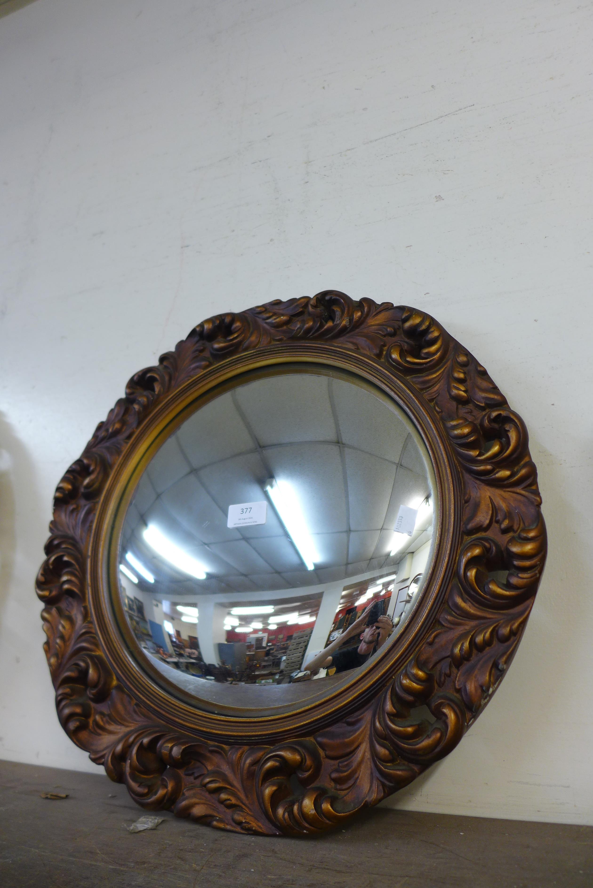 A gilt framed convex mirror