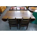 An oak drop-leaf table and four chairs