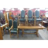 An oak draw-leaf dining table and six chairs