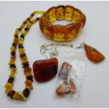 Amber and amber set jewellery including a pendant on a silver chain and one pair of earrings