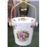 An ironstone cream floral decorated slop bucket with lid and cane handle