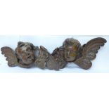 A pair of early 20th Century French carved wooden cherub wall hangings