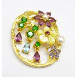 A silver gilt, carved pearl, Russian diopside, amethyst, topaz, tanzanite and zircon pendant