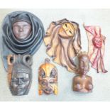 An African carved bust, wall plaques, Dominican Republic leather wall mounted masks, etc.