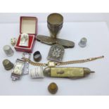 An Olma wristwatch, two pocket knives, one a/f, thimbles, etc.