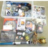 A collection of Star Wars items including a T-shirt, watch, Lego, audio cassettes, collectors cards,