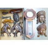 A box of African and other tourist carvings and a wooden wall clock