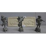 Three cast metal cherub figures and two angelic relief plaques