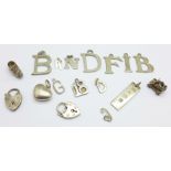 Thirteen silver charms and four white metal charms, mostly initial charms