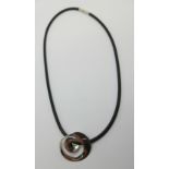 A Georg Jensen .925 silver pendant (2004 Torun) with matching rubber necklet with .925 silver
