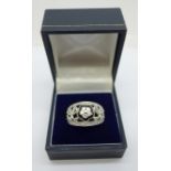 An 18ct white gold, diamond daisy cluster and onyx set ring, with 43 diamonds, insurance valuation