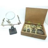 A hobbyists magnifying glass and a part cased watch tool set