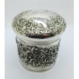 A Victorian embossed silver jar, Birmingham 1897, 137g, the lid bears name, Moss, (some perforations