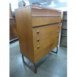 A teak chest of drawers