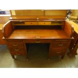 An early 20th Century oak tambour roll top desk