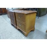 A pair of small teak bedside chests