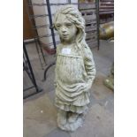 A concrete garden ornament of a girl