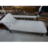 A Victorian carved beech and upholstered chaise longue