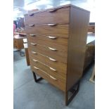 A teak chest of drawers