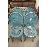 A set of four cast alloy garden chairs