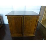 An early 20th Century oak fitted table top cabinet