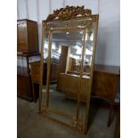 A large French style gilt framed mirror with crest, 183cms x 92cms w (M32138) #