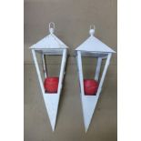 A pair of painted metal hanging candle lanterns