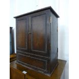 An early 20th Century oak table top double sided cabinet