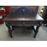 A Victorian Jacobean Revival carved oak side table