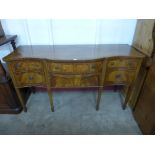 A Regency style inlaid mahogany serpentine sideboard