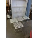 A set of four painted metal folding garden chairs