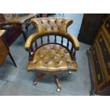 A mahogany and brown leather desk chair