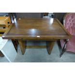 An Art Deco walnut draw-leaf dining table