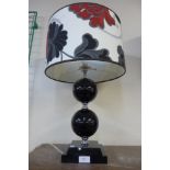 A black globular table lamp