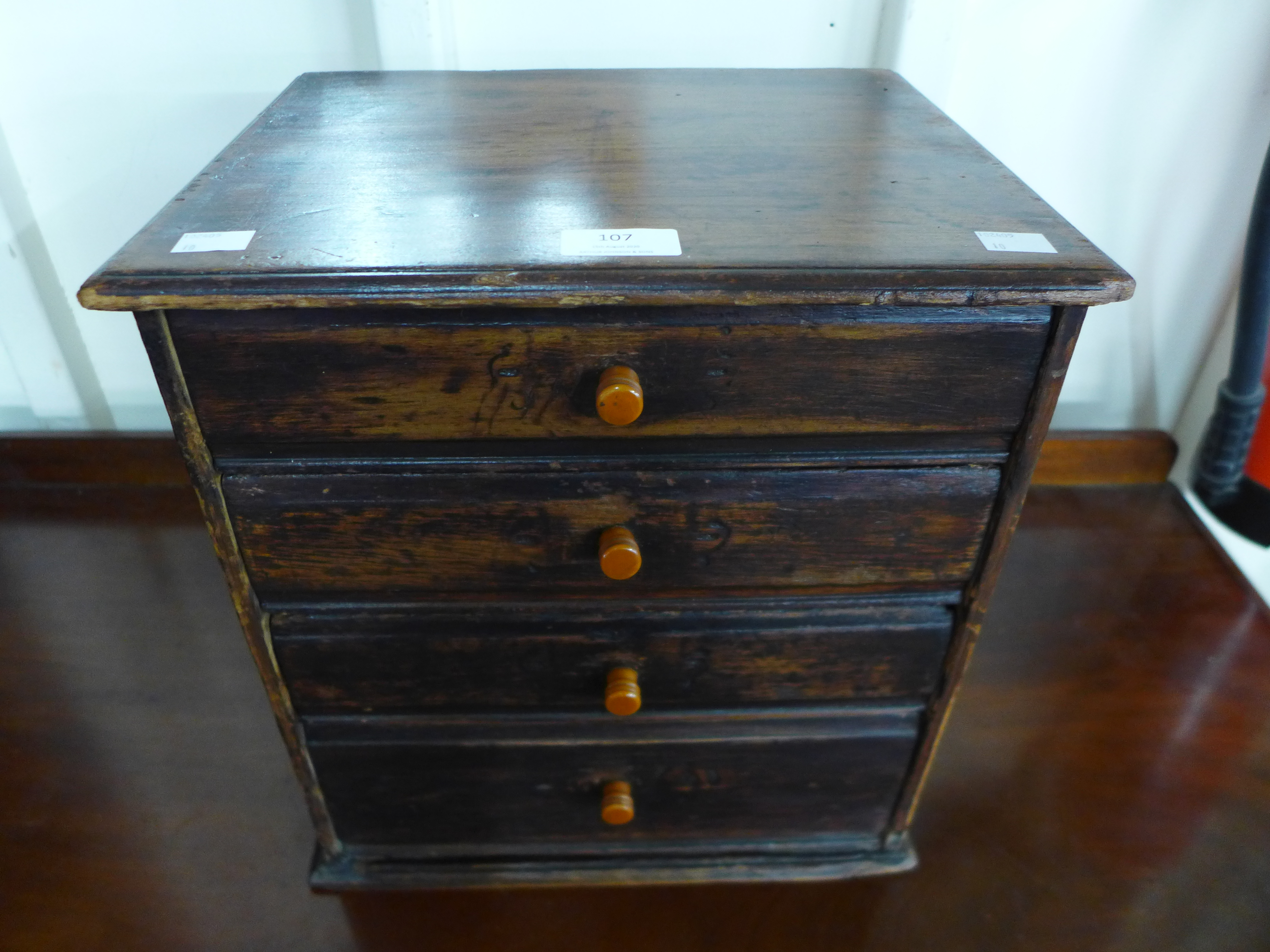 An early 20th Century canary wood table top four drawer chest, made by Henry Stone & Son, 36cms h, - Image 2 of 3