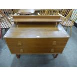 A teak chest of drawers