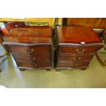 A pair of small mahogany serpentine chests of drawers