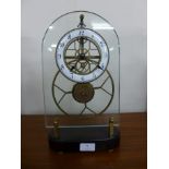 A French style brass and glass faced skeleton clock